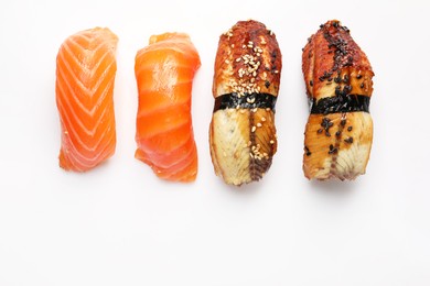 Photo of Delicious nigiri sushi on white background, flat lay