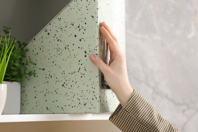 Photo of Woman taking folder from shelf in office, closeup