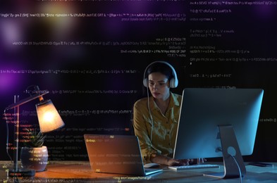 Image of Programmer with headphones working in office at night