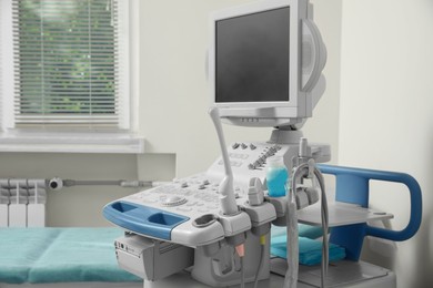 Photo of Ultrasound machine and examination table in hospital