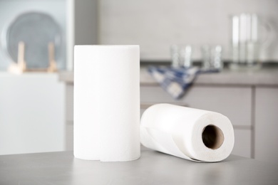 Photo of Rolls of paper towels on table in kitchen