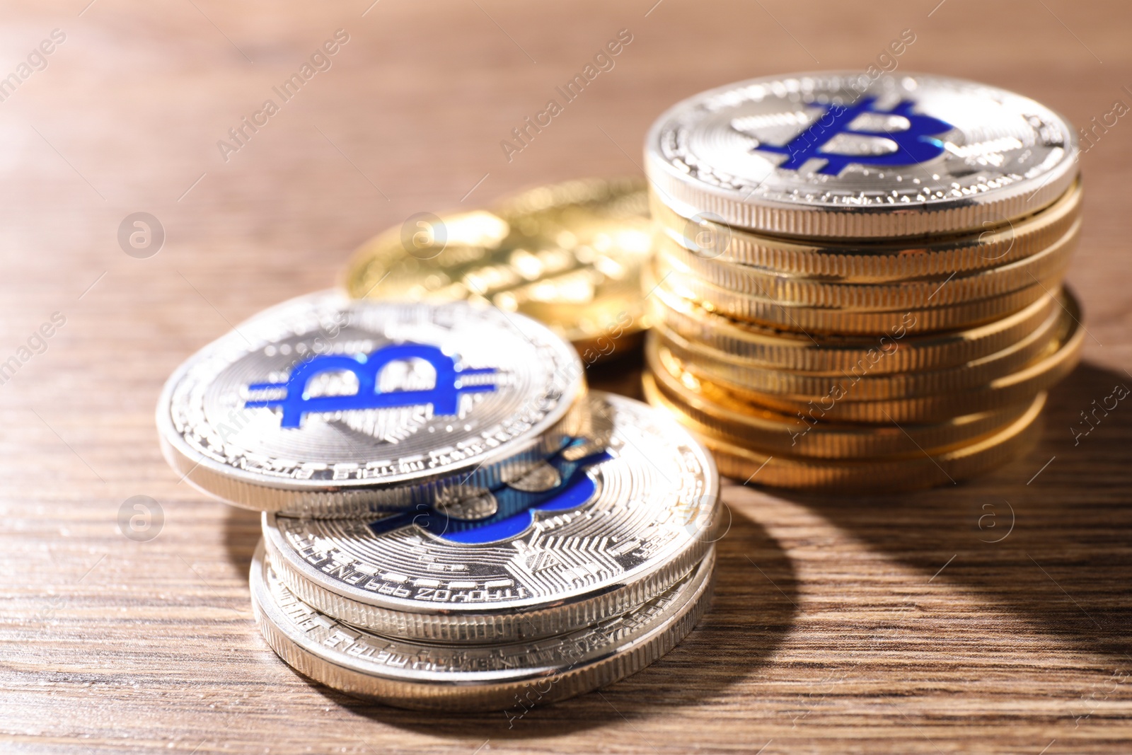 Photo of Shiny bitcoins on wooden background. Digital currency