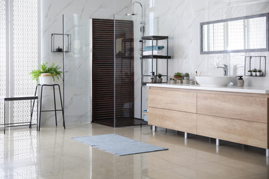 Photo of Bathroom interior with shower stall, counter and houseplants. Idea for design