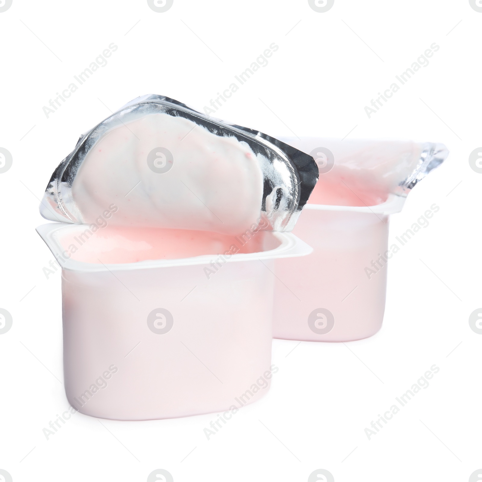 Photo of Tasty organic yogurt in plastic cups isolated on white