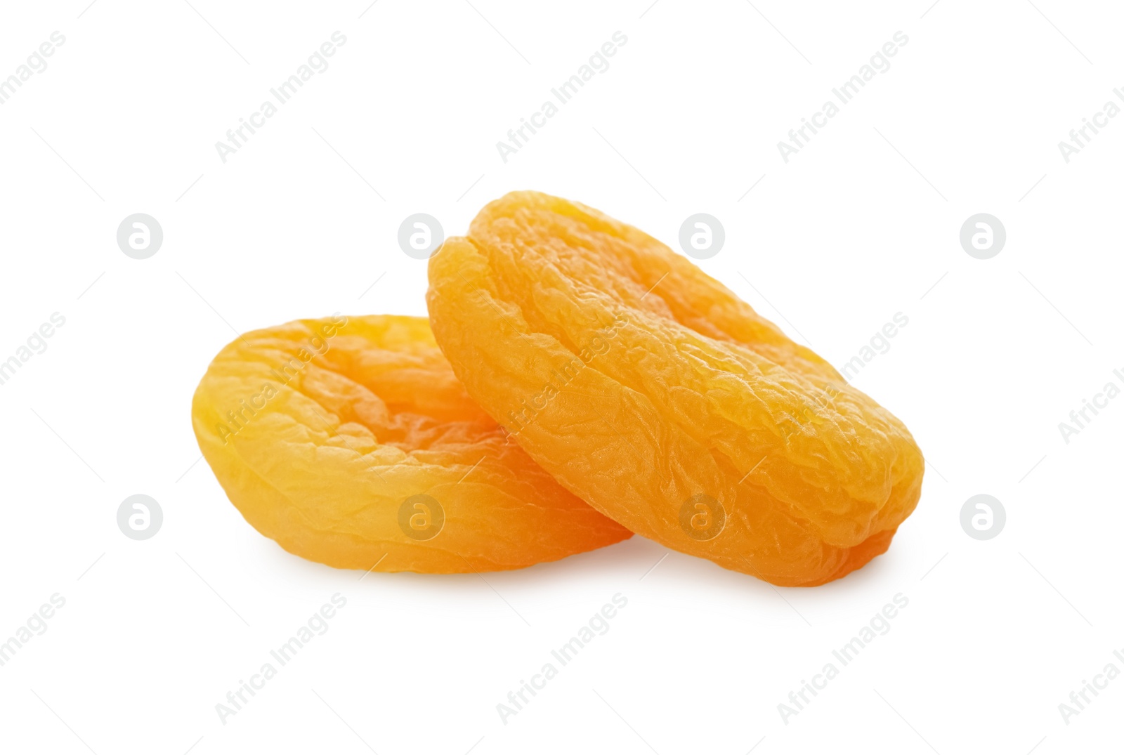 Photo of Two tasty apricots on white background. Dried fruits