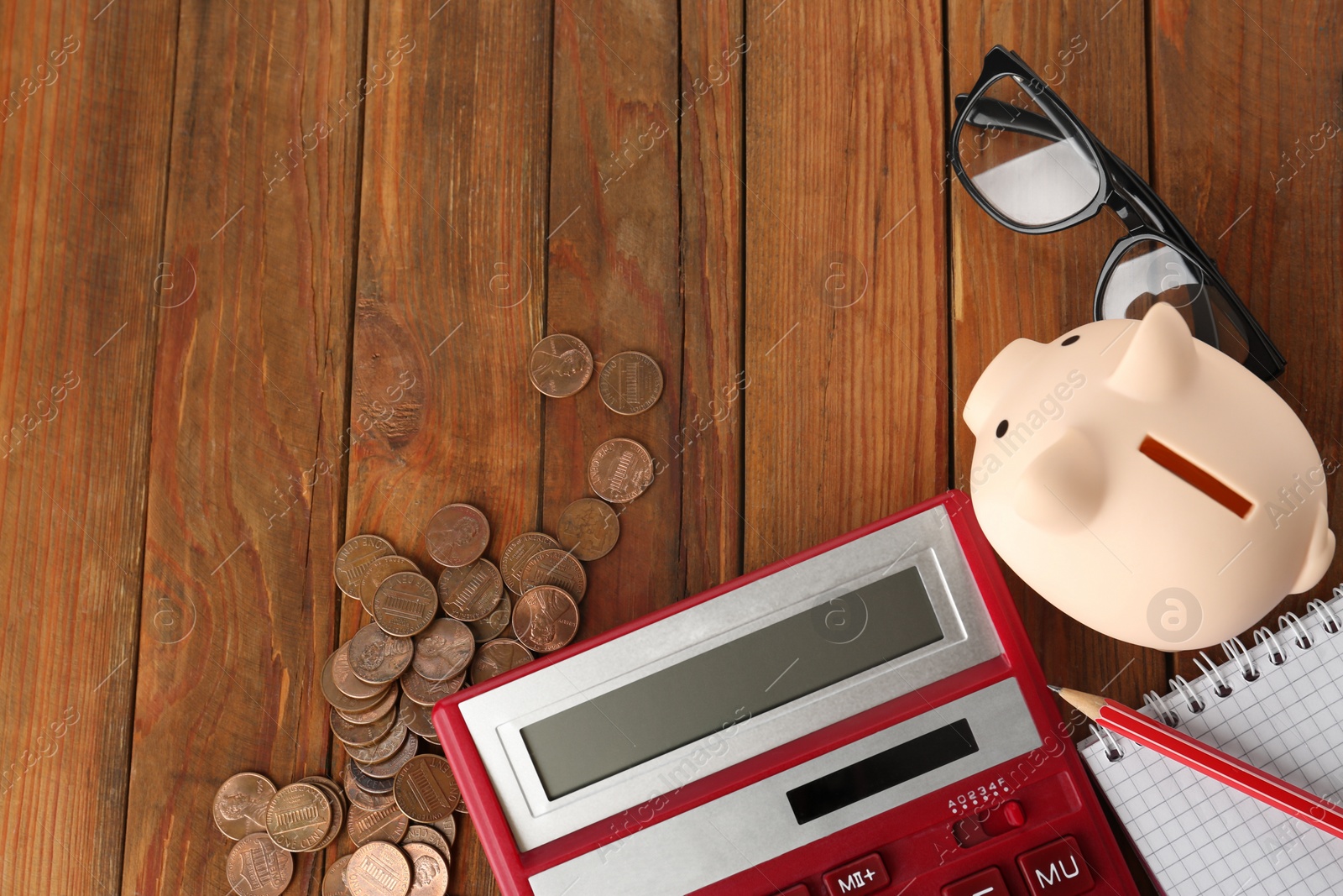 Photo of Flat lay composition with calculator, coins and piggy bank on wooden table. Space for text