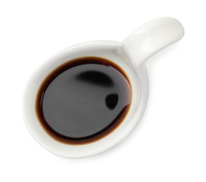 Photo of Tasty soy sauce in gravy boat isolated on white, top view