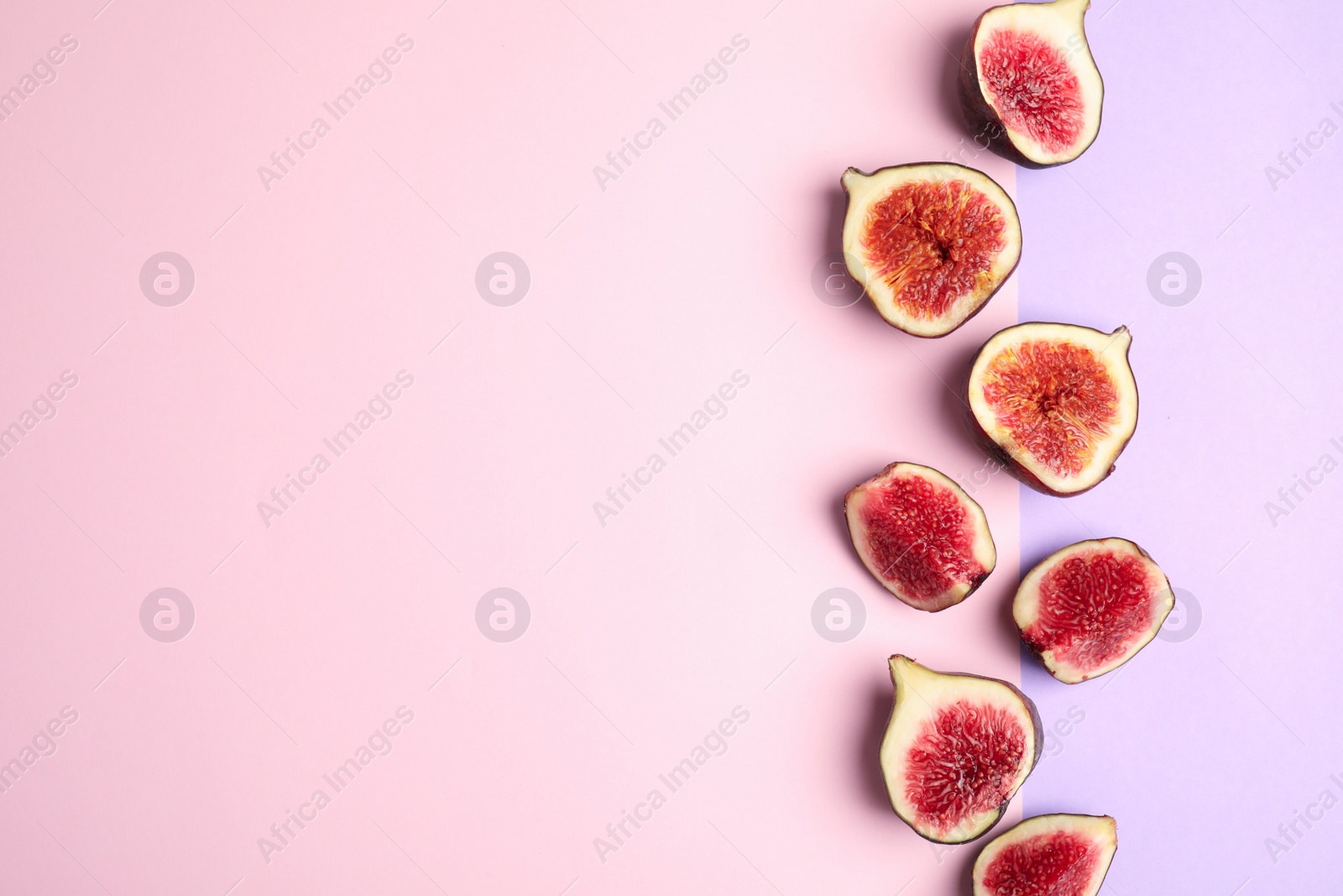 Photo of Delicious ripe figs on color background, flat lay. Space for text