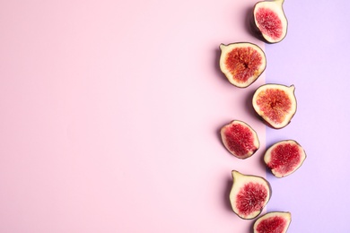 Photo of Delicious ripe figs on color background, flat lay. Space for text