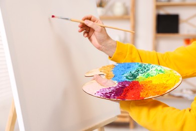 Man painting on canvas in studio, closeup