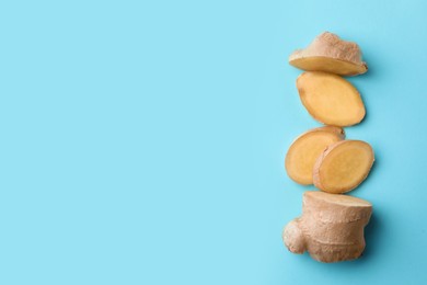Photo of Fresh ginger on pale light blue background, flat lay. Space for text