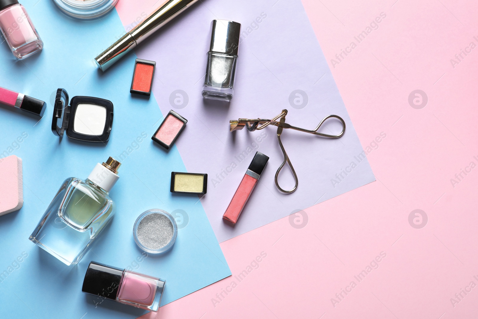 Photo of Decorative cosmetics and tools of professional makeup artist on color background