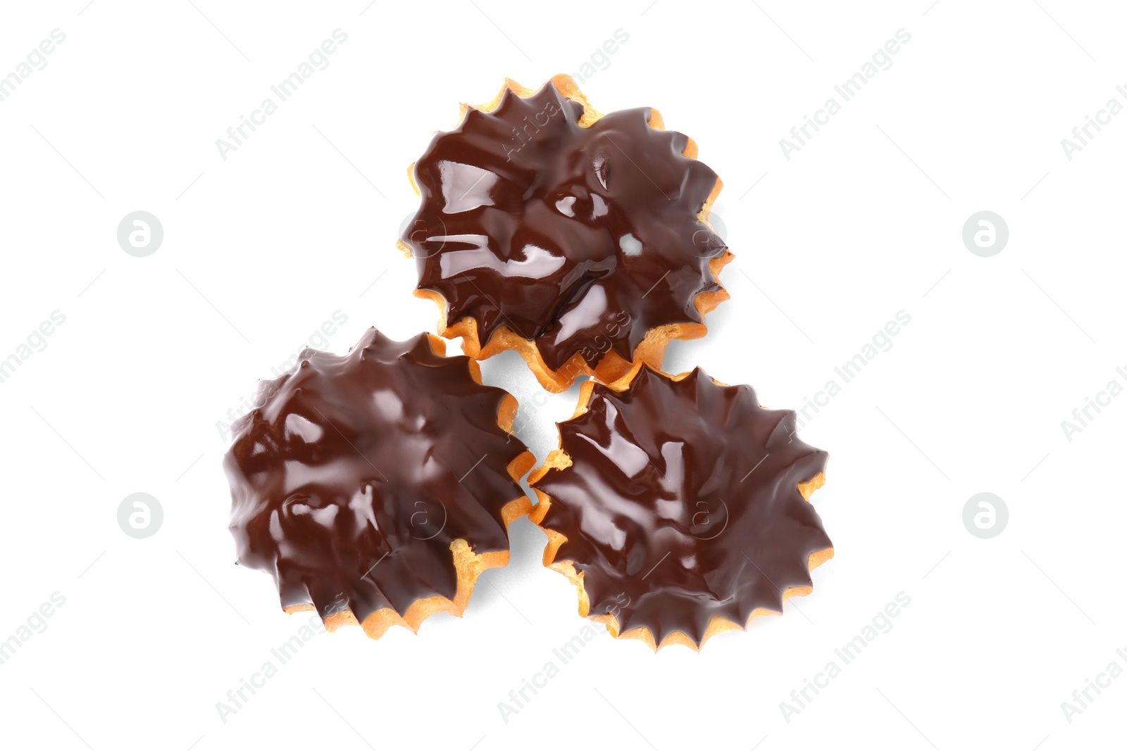 Photo of Delicious profiteroles with chocolate spread isolated on white, top view