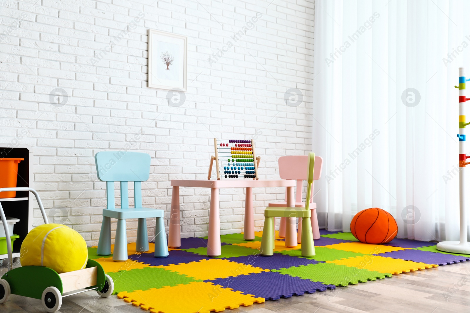 Photo of Stylish playroom interior with toys and modern furniture