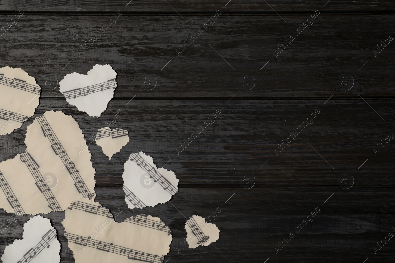 Photo of Paper hearts with music notes and space for text on wooden background, flat lay