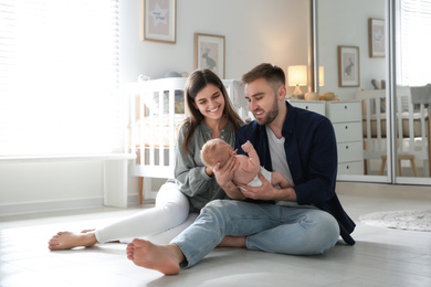 Happy couple with their newborn baby at home