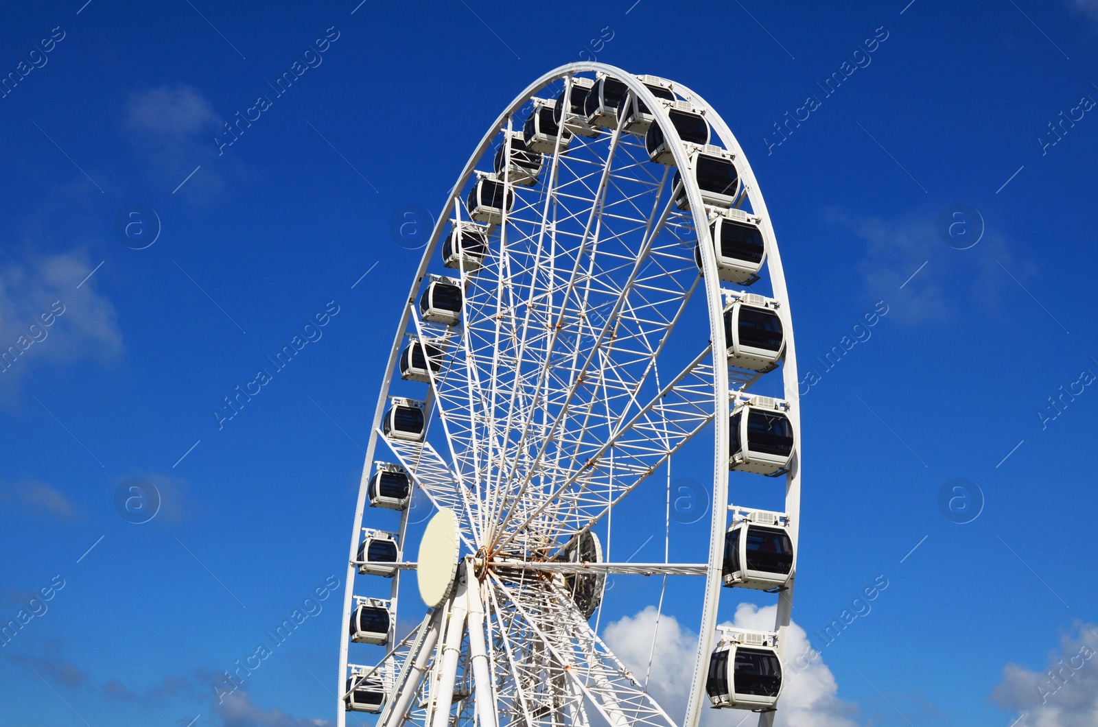 Photo of Beautiful large Ferris wheel against blue sky