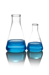 Conical flasks with liquid on table against white background. Laboratory analysis