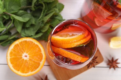 Photo of Delicious punch drink and ingredients on white table, flat lay