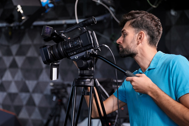 Photo of Professional video camera operator working in studio