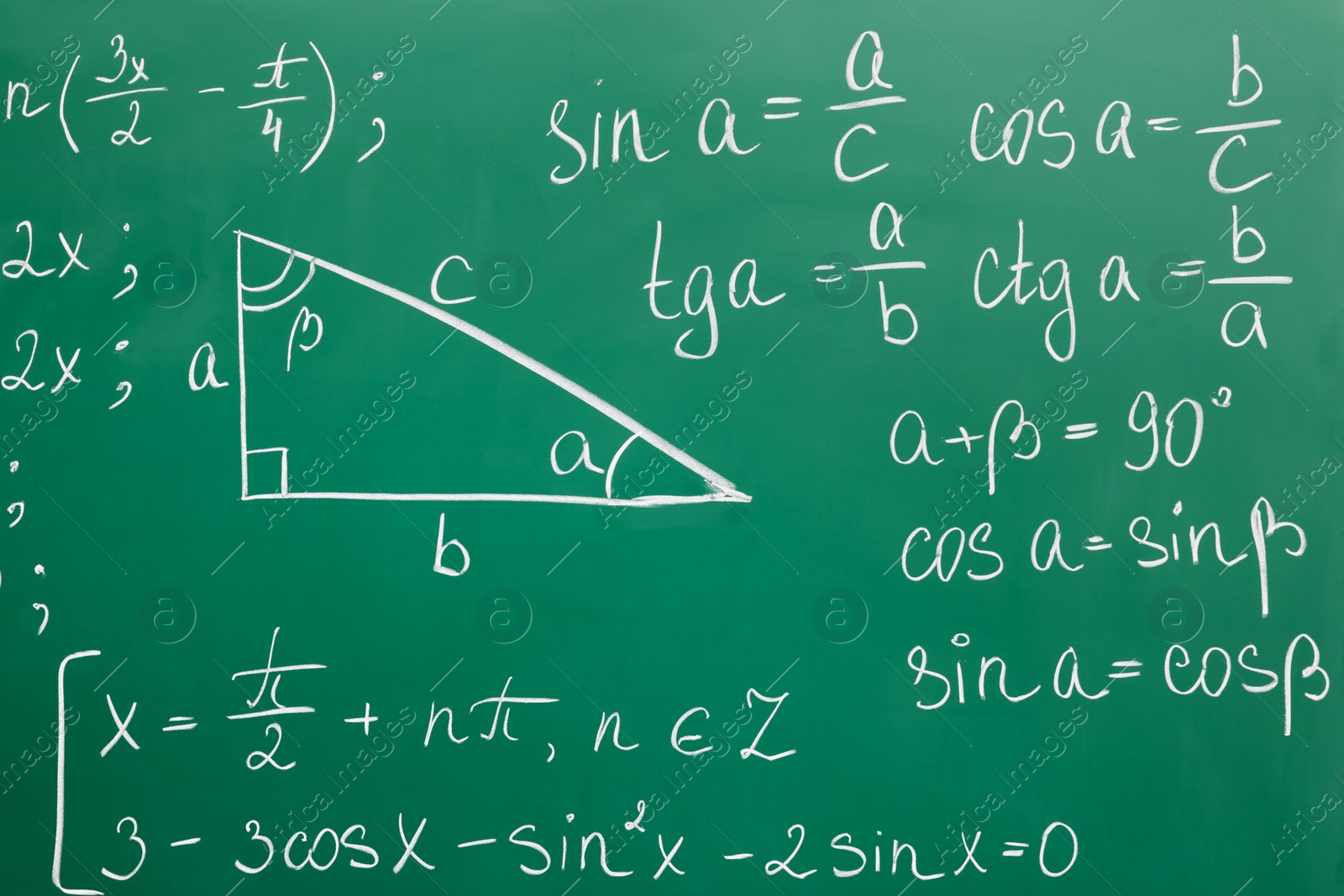 Photo of Many different math formulas written on green chalkboard