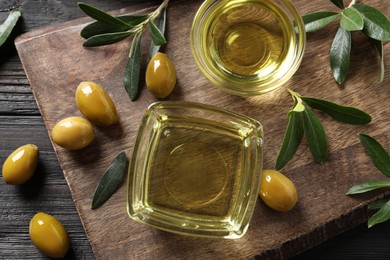 Photo of Flat lay composition with olive oil on black wooden table