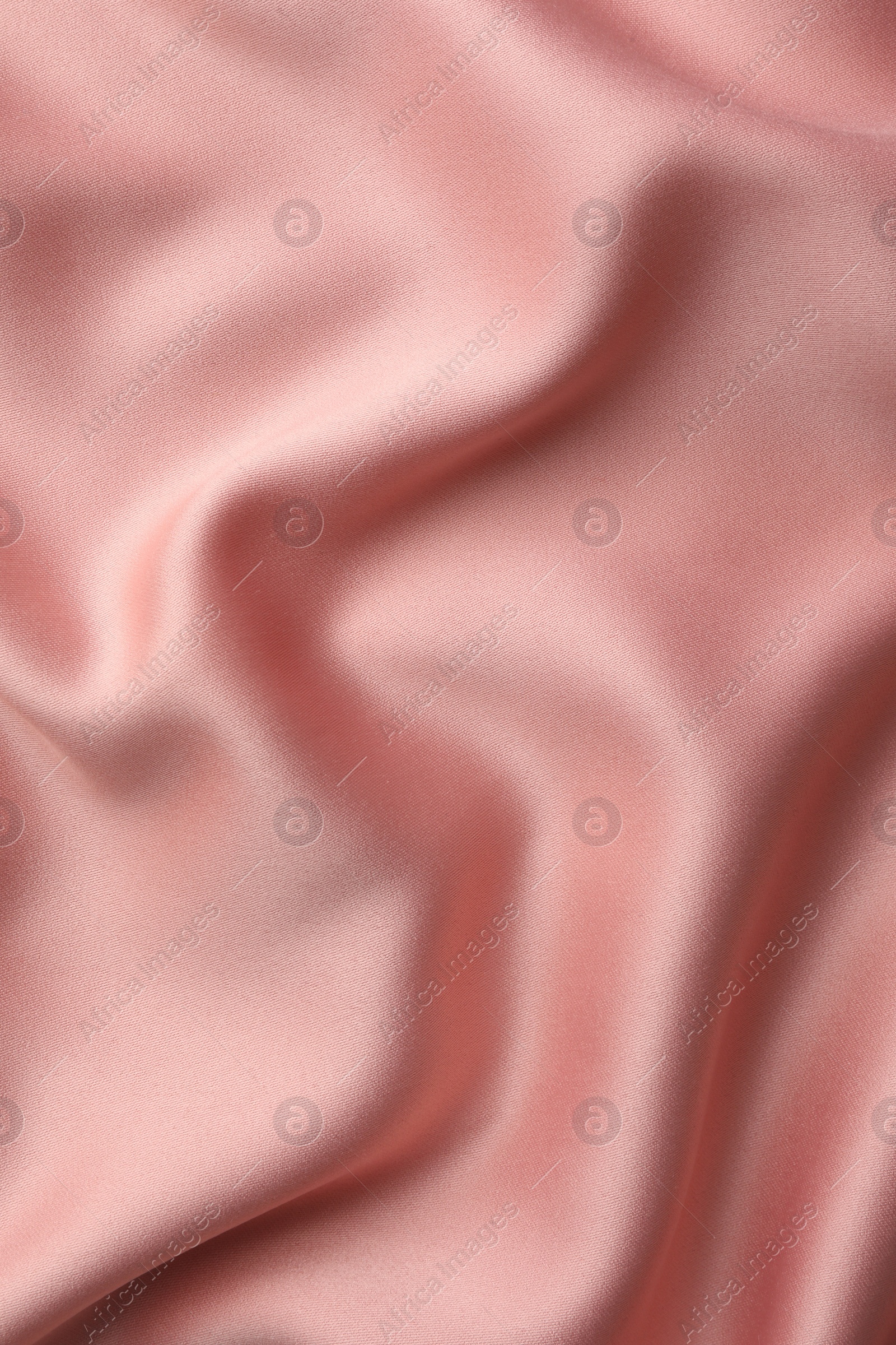 Photo of Crumpled pink silk fabric as background, top view