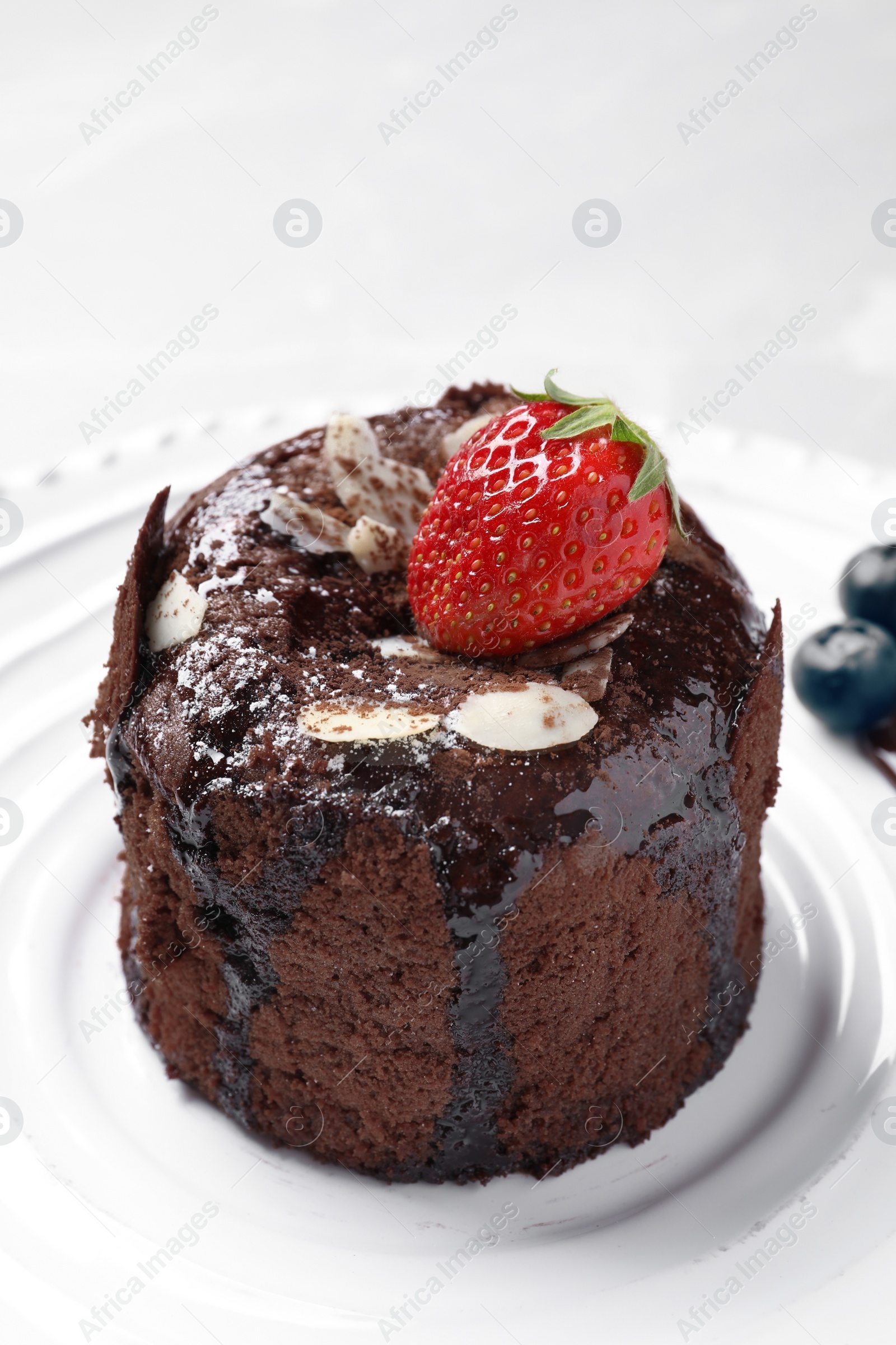 Photo of Delicious fresh fondant with hot chocolate and berries served on plate. Lava cake recipe