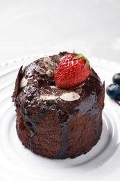 Delicious fresh fondant with hot chocolate and berries served on plate. Lava cake recipe