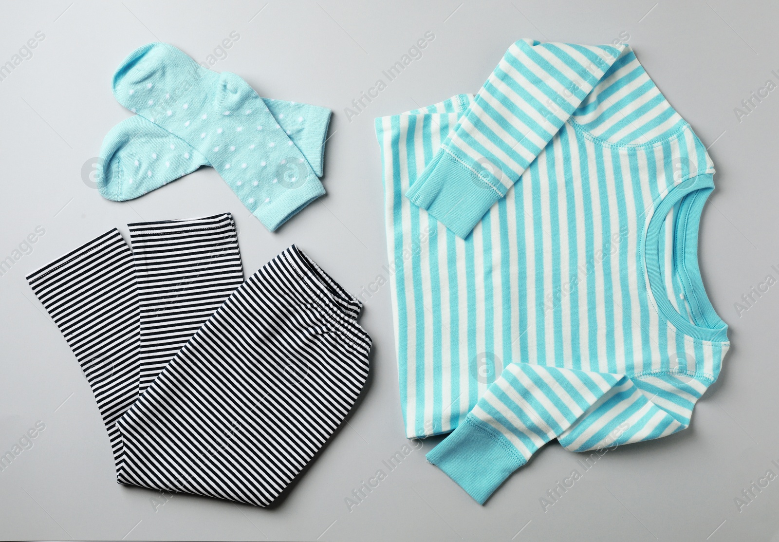 Photo of Flat lay composition with cute child clothes on color background