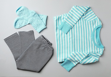 Photo of Flat lay composition with cute child clothes on color background