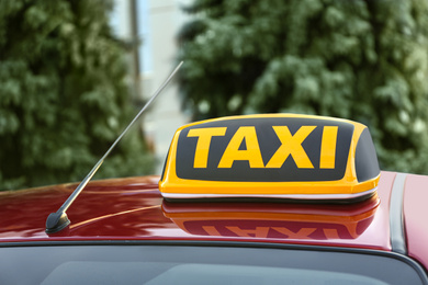 Photo of Roof light with word TAXI on car outdoors