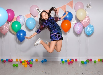 Photo of Happy girl having fun at birthday party indoors