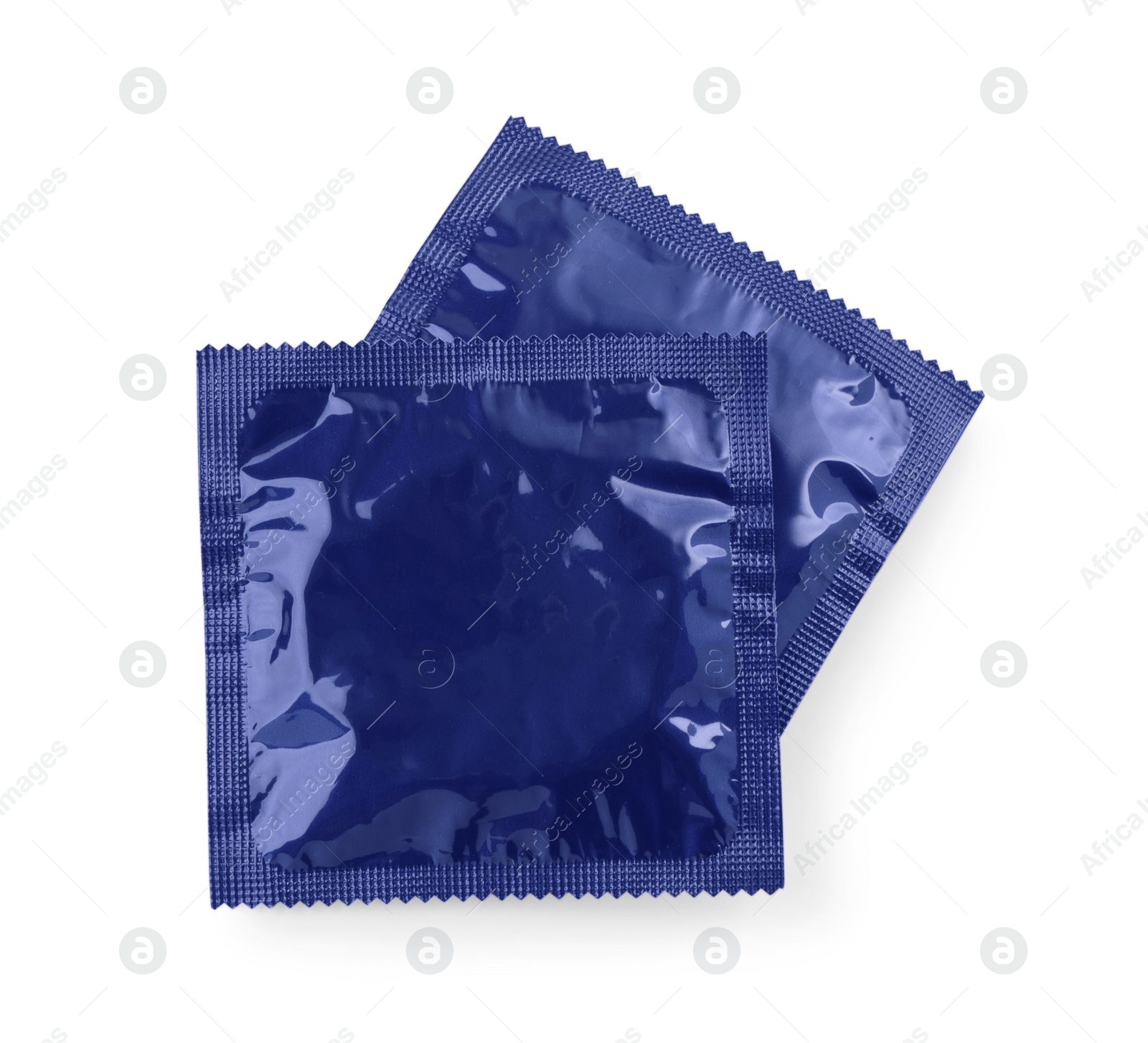 Photo of Packaged condoms on white background, top view. Safe sex