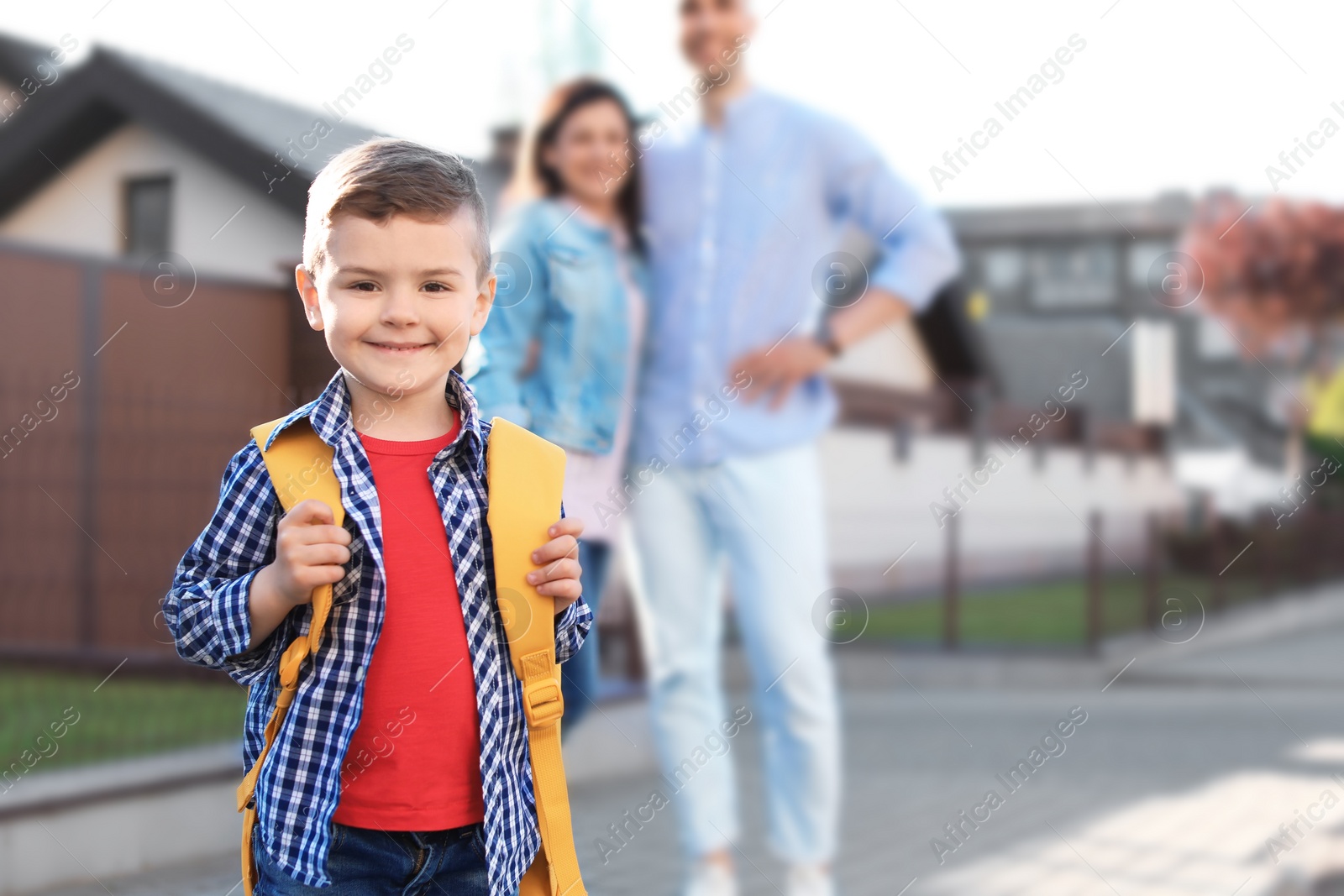 Photo of Young parents seeing their little child off to school
