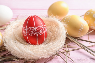 Photo of Composition with painted Easter eggs on table. Space for text