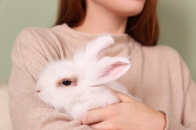 Photo of Woman with fluffy white rabbit, closeup. Cute pet