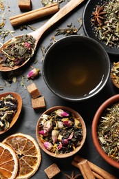 Photo of Flat lay composition with fresh brewed tea and dry leaves on grey table