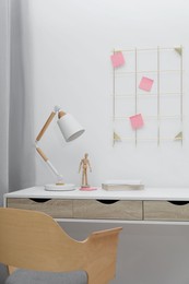 Photo of Desk lamp on table in stylish room