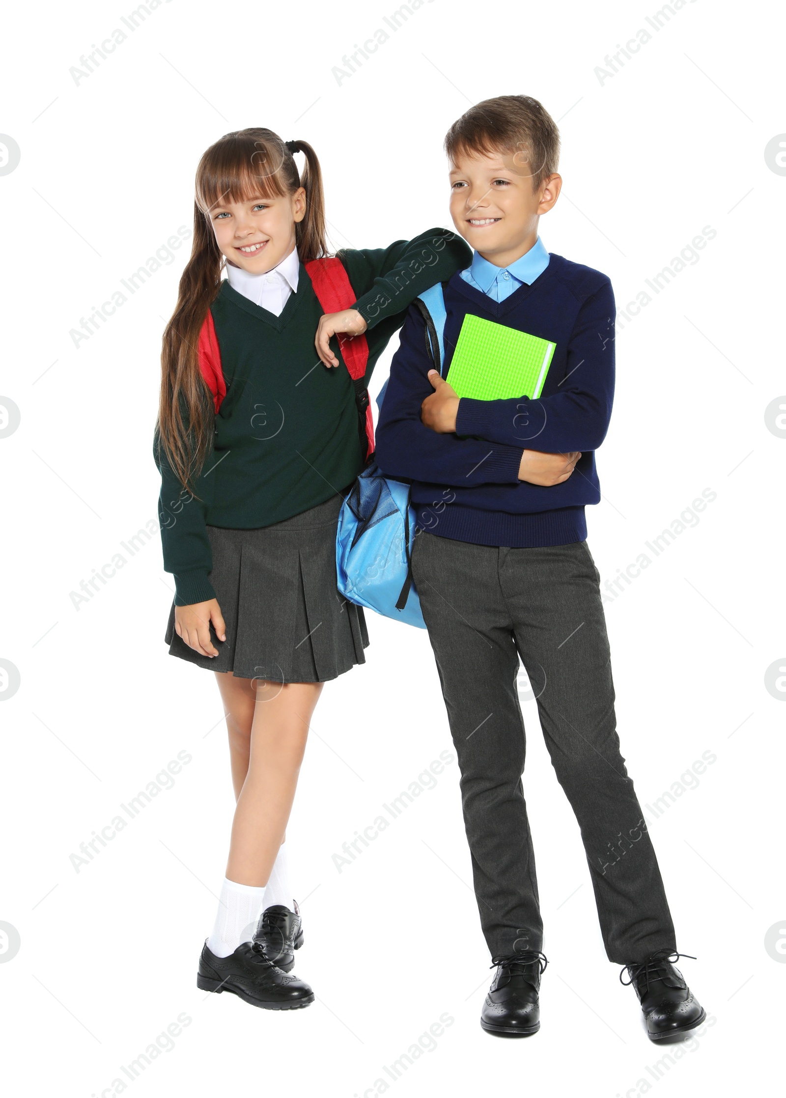 Photo of Little children in stylish school uniform on white background