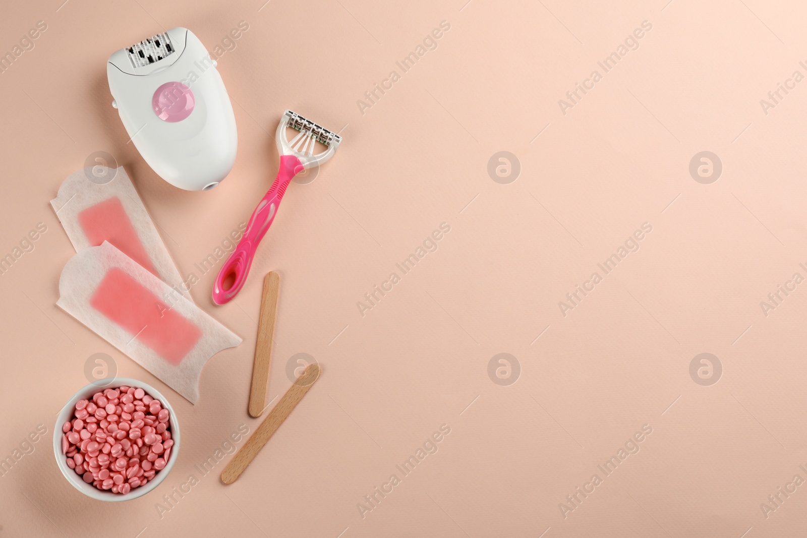 Photo of Set of epilation products on beige background, flat lay. Space for text