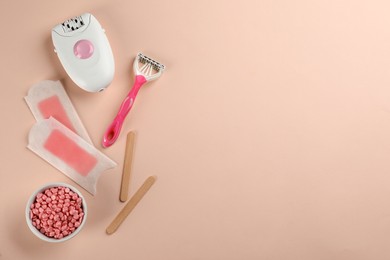 Set of epilation products on beige background, flat lay. Space for text