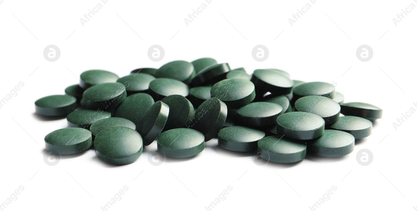 Photo of Heap of spirulina tablets on white background