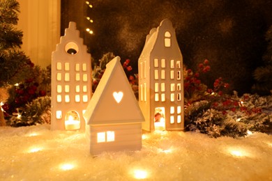 House shaped lanterns and Christmas decor on windowsill indoors