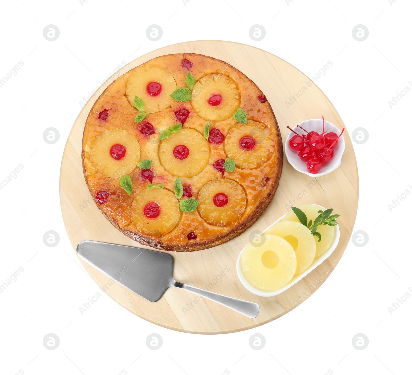 Photo of Board with tasty pineapple cake and ingredients isolated on white, top view