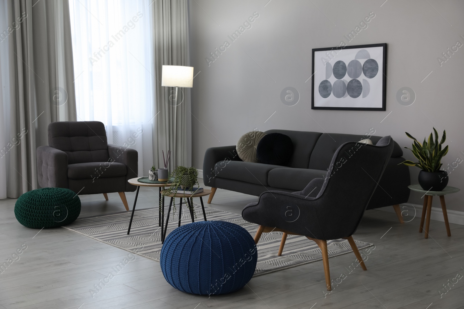 Photo of Stylish comfortable poufs and sofa in room. Home design