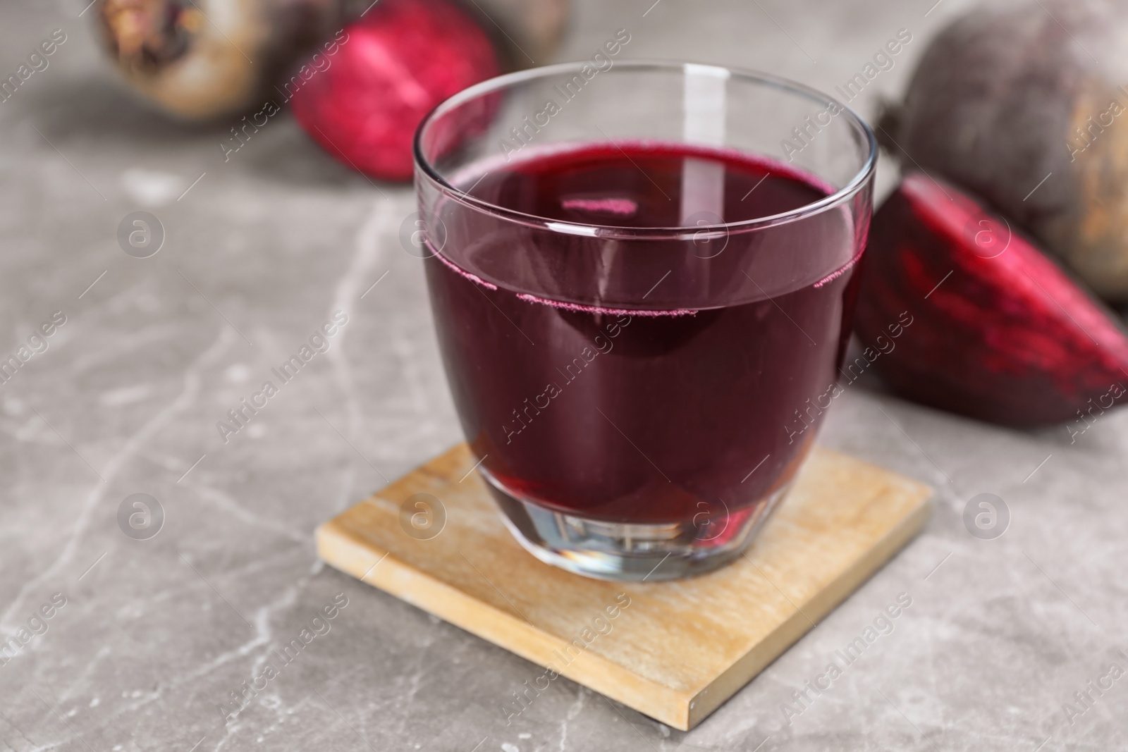 Photo of Glass with fresh healthy beet juice on table