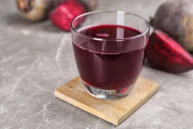 Photo of Glass with fresh healthy beet juice on table