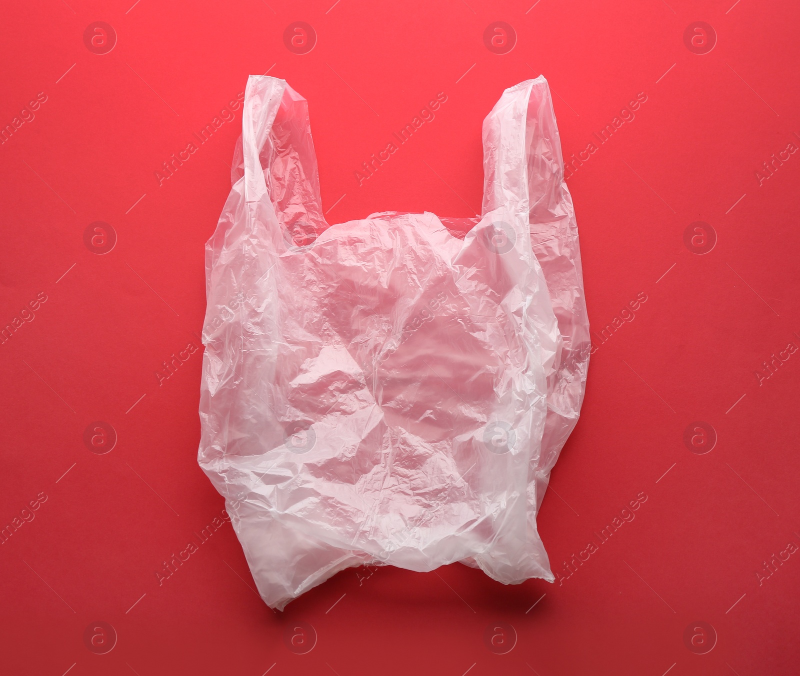 Photo of Clear disposable plastic bag on color background