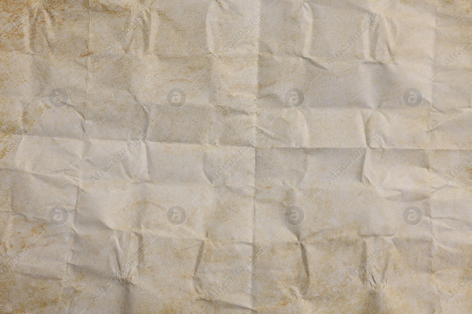 Photo of Texture of crumpled parchment paper as background, top view